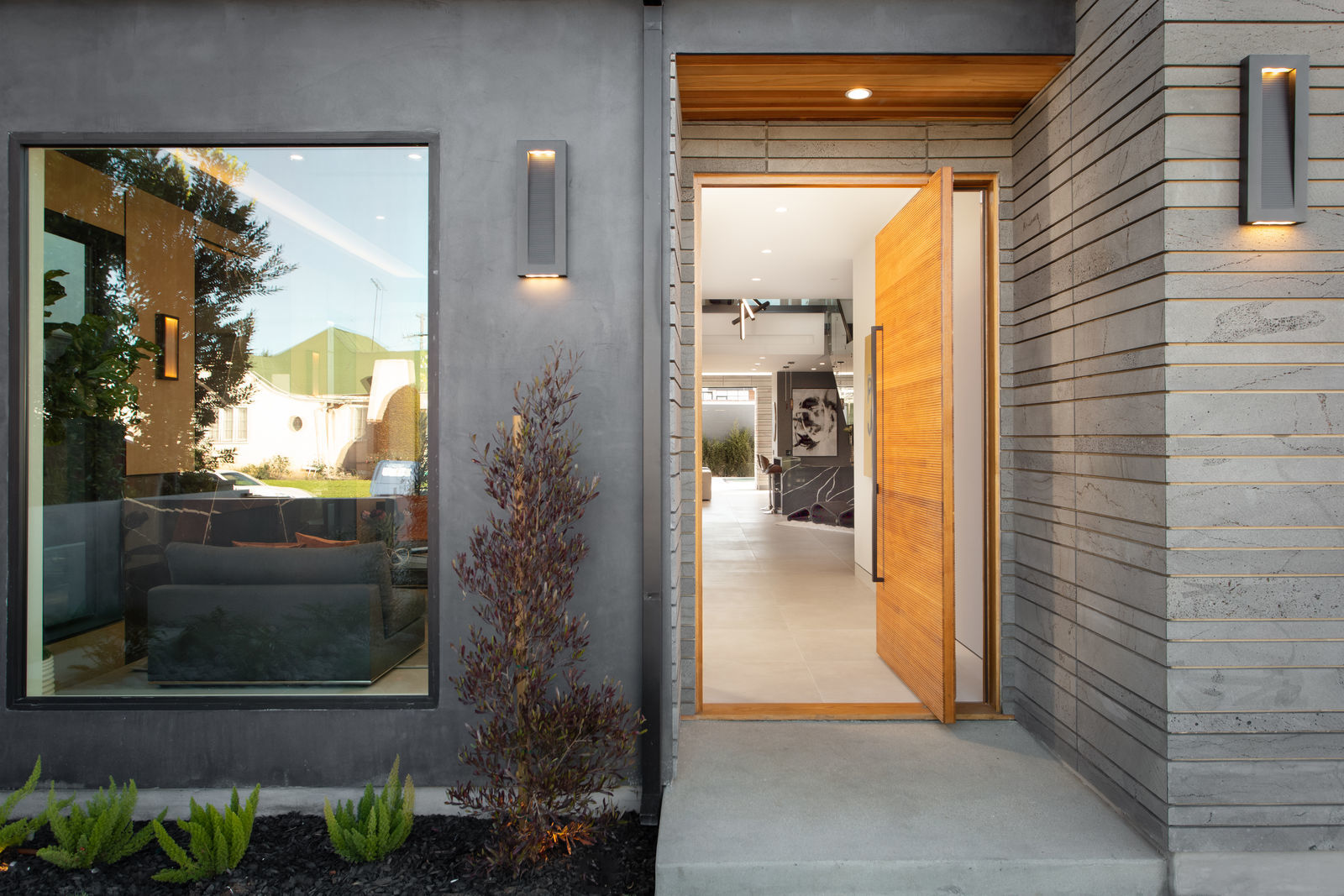 Norstone Platinum Planc large format tile around front door and on entryway wall in modern styled home in California